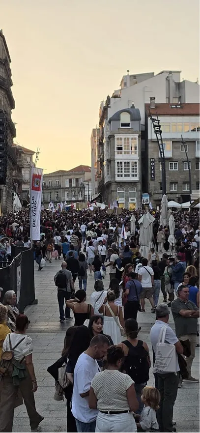 Multitud llenando una plaza del centro de Vigo al atardecer durante la manifestación por la vivienda
